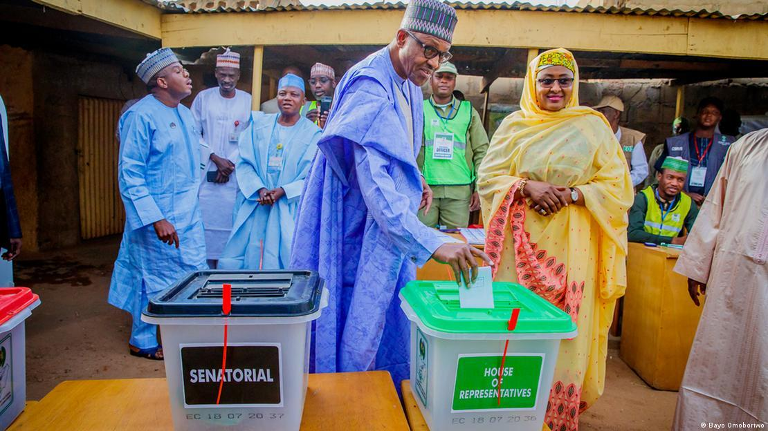 Voters casting ballots into labelled senatorial and House of Representatives ballot boxes